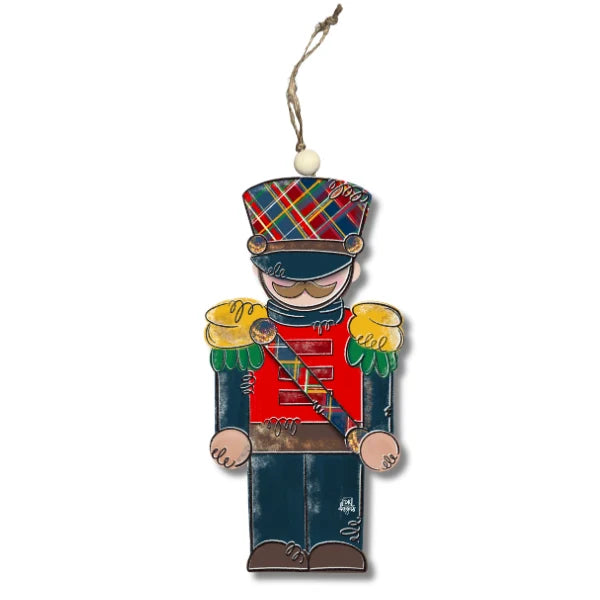 Decorative ornament of a toy soldier with plaid hat on a white background