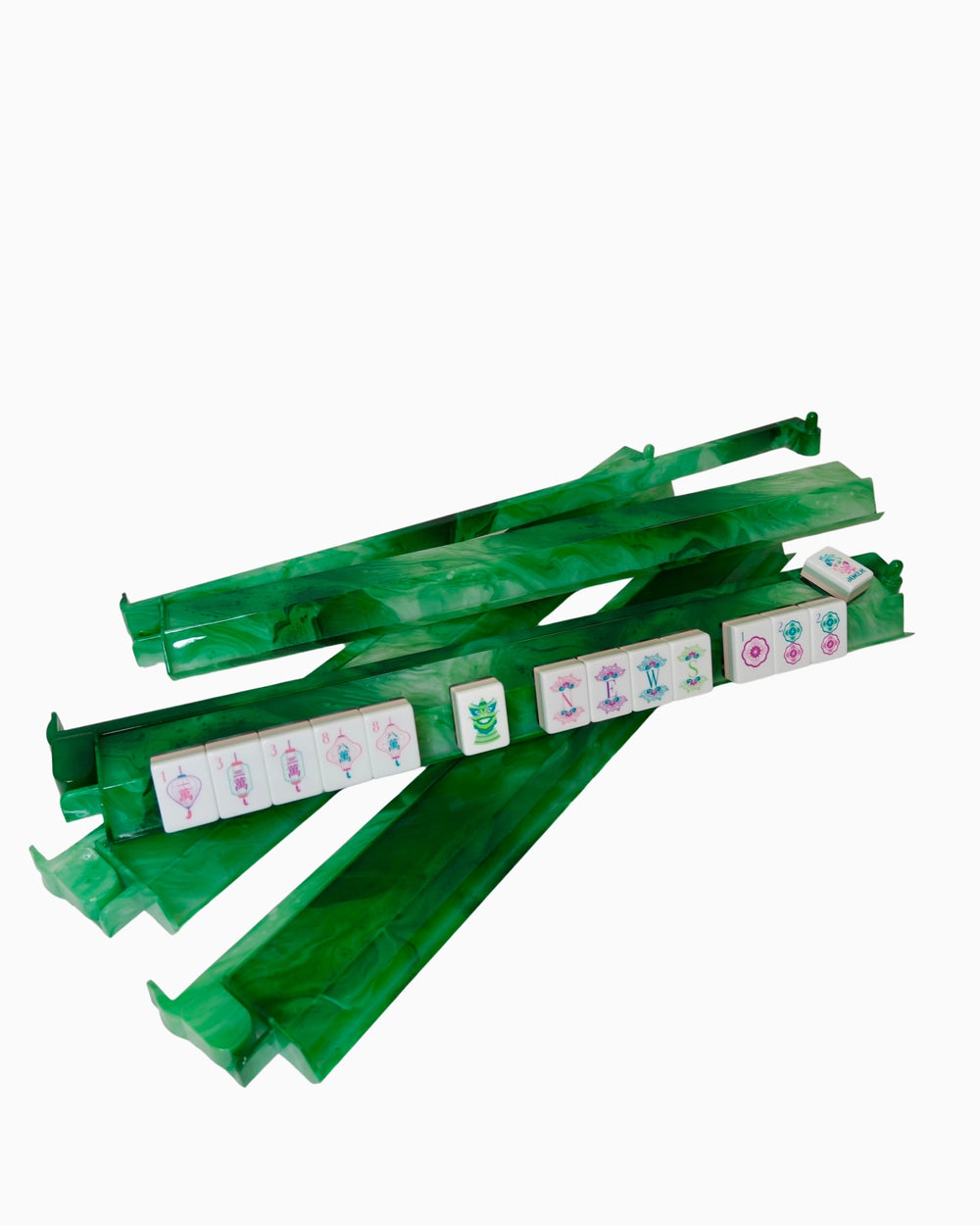Green acrylic rack and pushers with colorful tiles on a white background