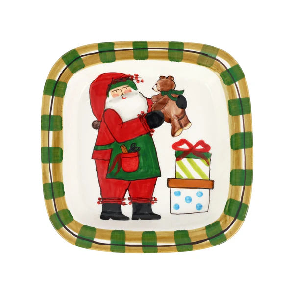 Decorative plate with Santa Claus holding a teddy bear and gift, surrounded by green and gold checkered border.