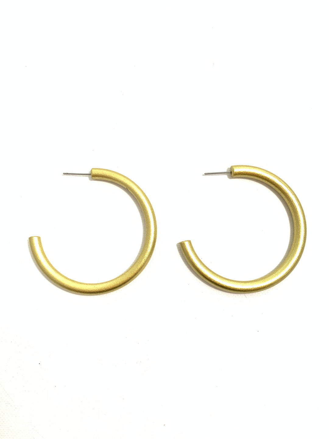 A pair of gold-toned metal half-hoop earrings with small pin-back backs, displayed on a plain white background.