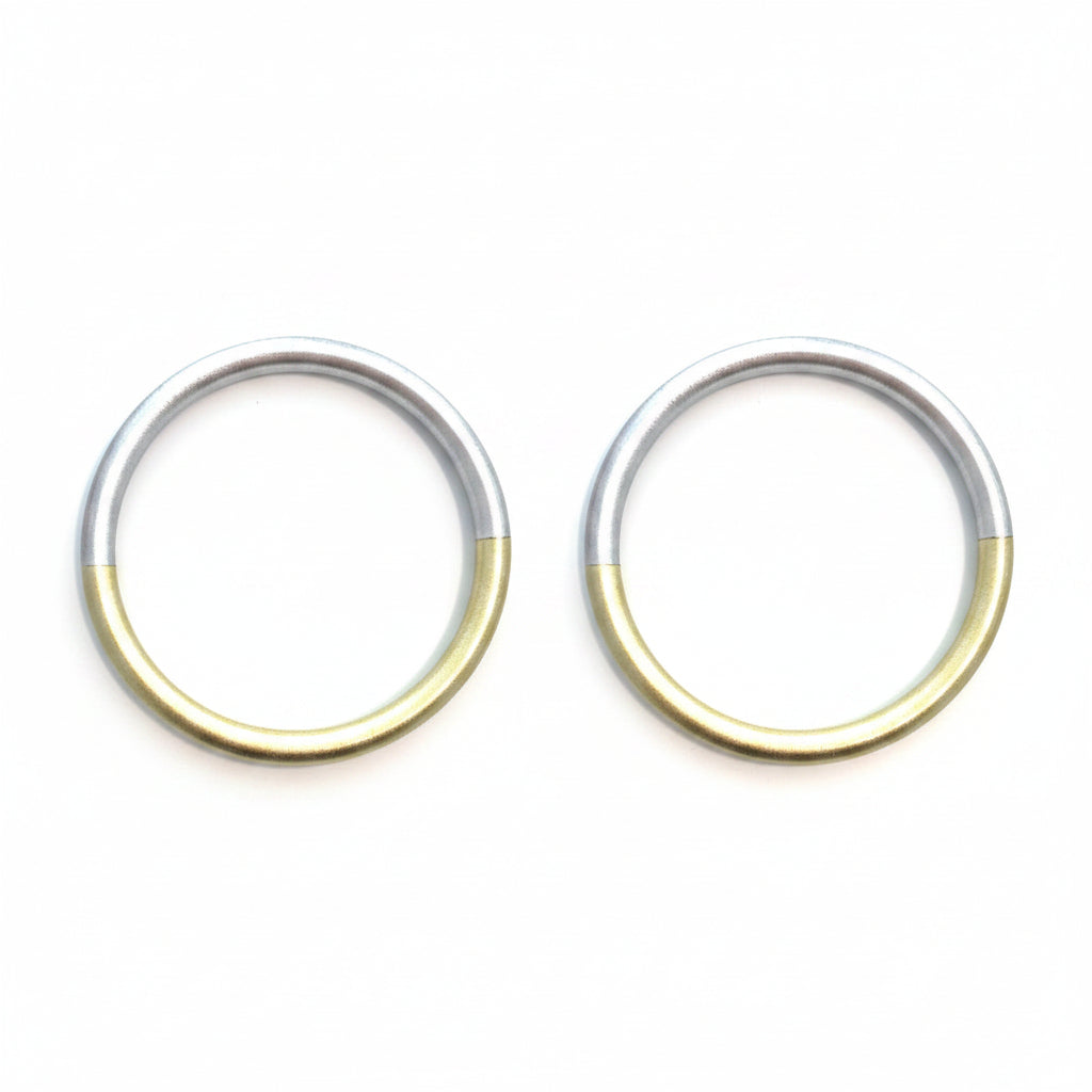 Two-toned circular ring with gold and silver colors on a white background