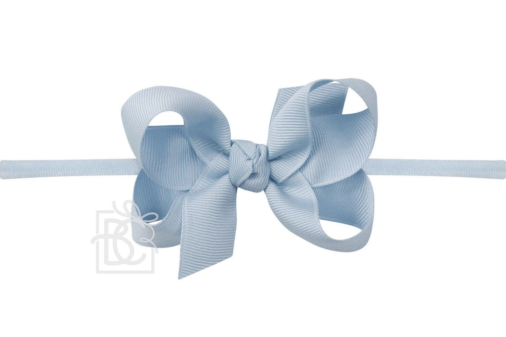 A blue bow pantyhose headband against a white background.