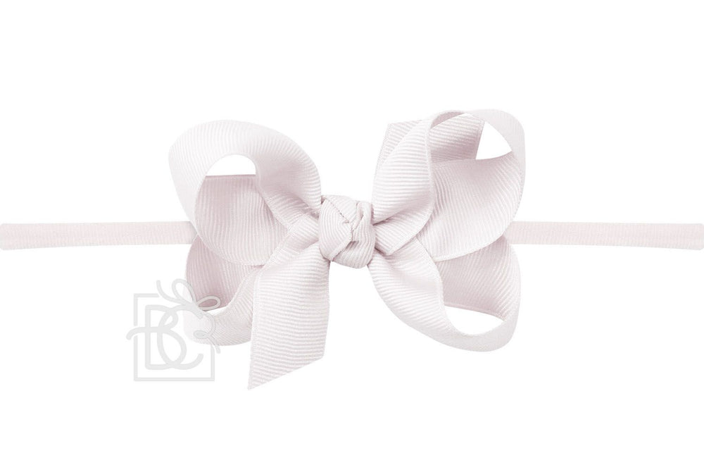 A pink pantyhose headband with a bow