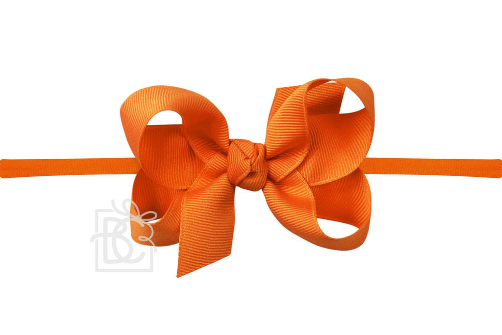 Orange bow pantyhose headband on a white background