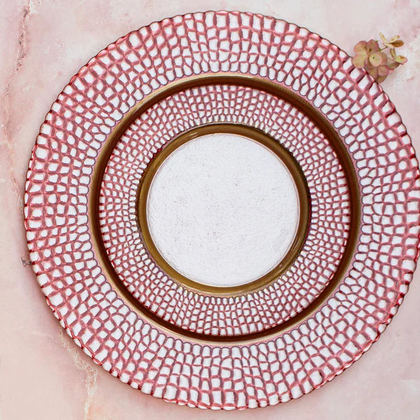 Decorative plate with red geometric pattern on a pink background