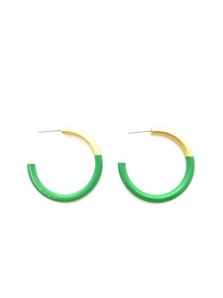Green and gold hoop earrings on a white background