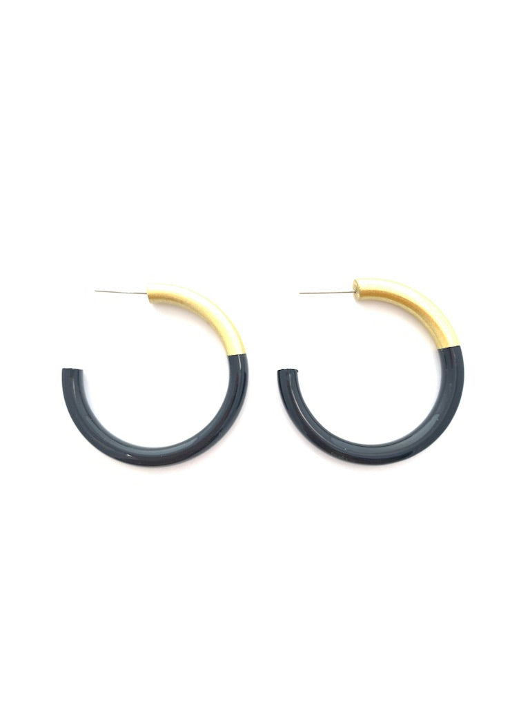 Black and gold hoop earrings on a white background