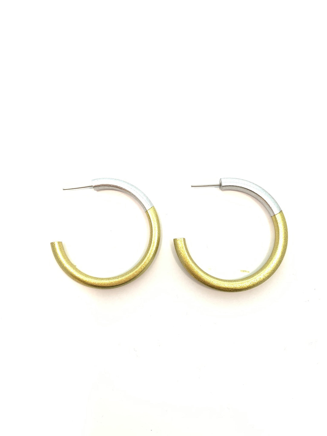 A pair of gold and silver split hoop earrings on a plain white background.