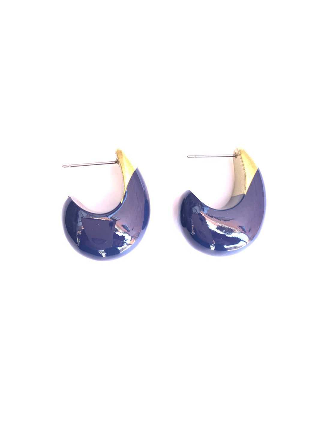 A pair of crescent-shaped stud earrings with a glossy dark blue enamel body and a gold-toned beak-like accent on a plain white background.