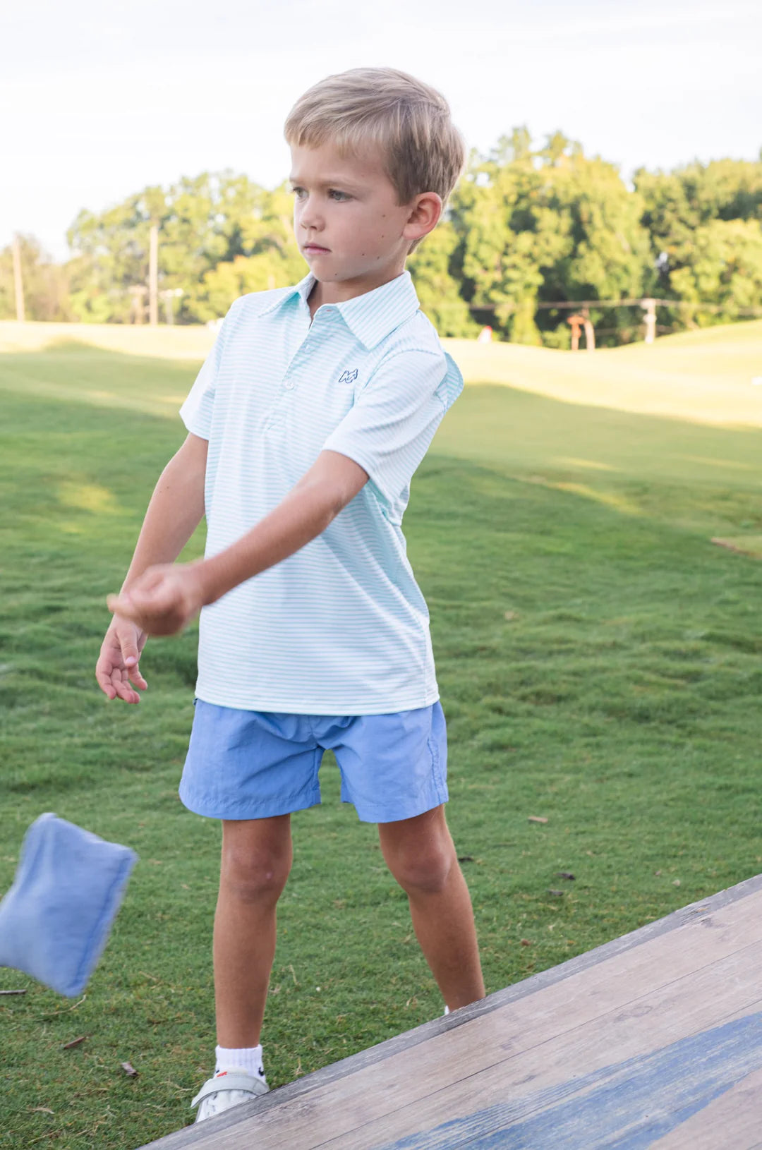 LITTLE BOY OUTSIDE IN LIGHT BLUE STRIPE BOYS SHORT SLEEVE POLO WITH COLLAR AND BLUE SHORTS