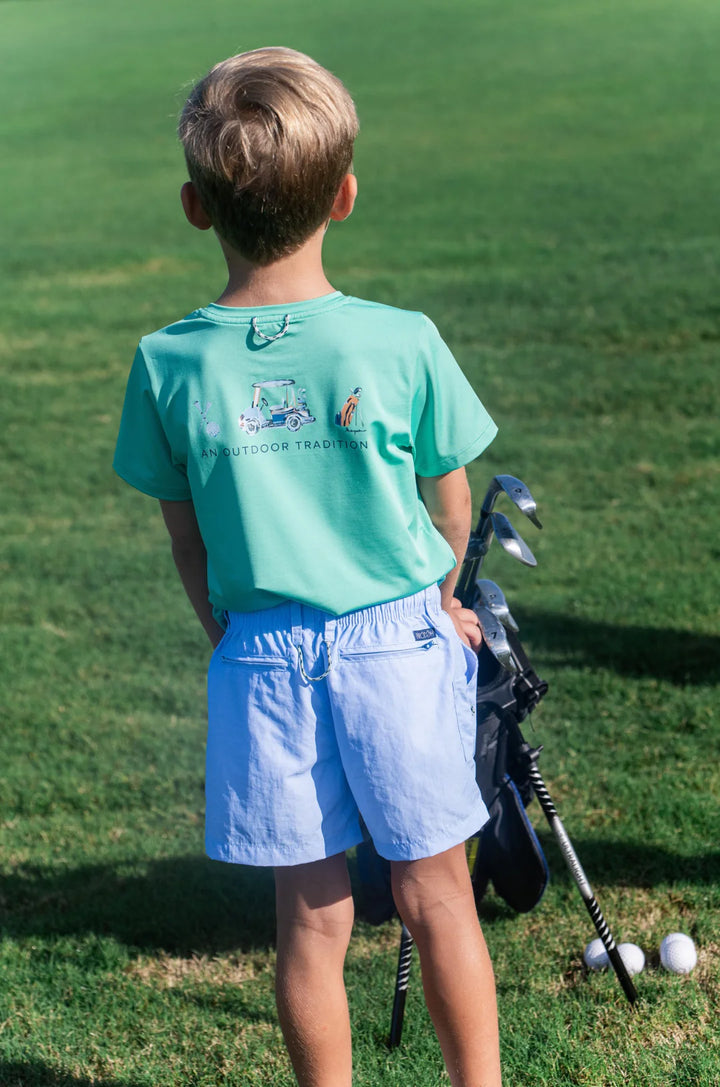 LITTLE BOY WEARING SHORT SLEEVE LIGHT GREEN PERFORMANCE T-SHIRT ON GOLF COURSE