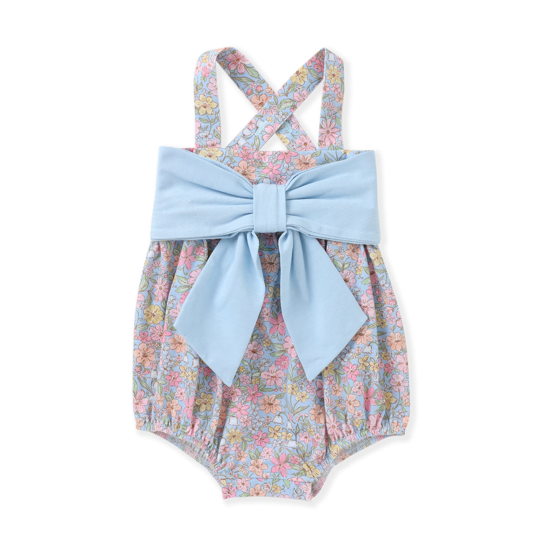 Floral baby romper with a large blue bow on a white background