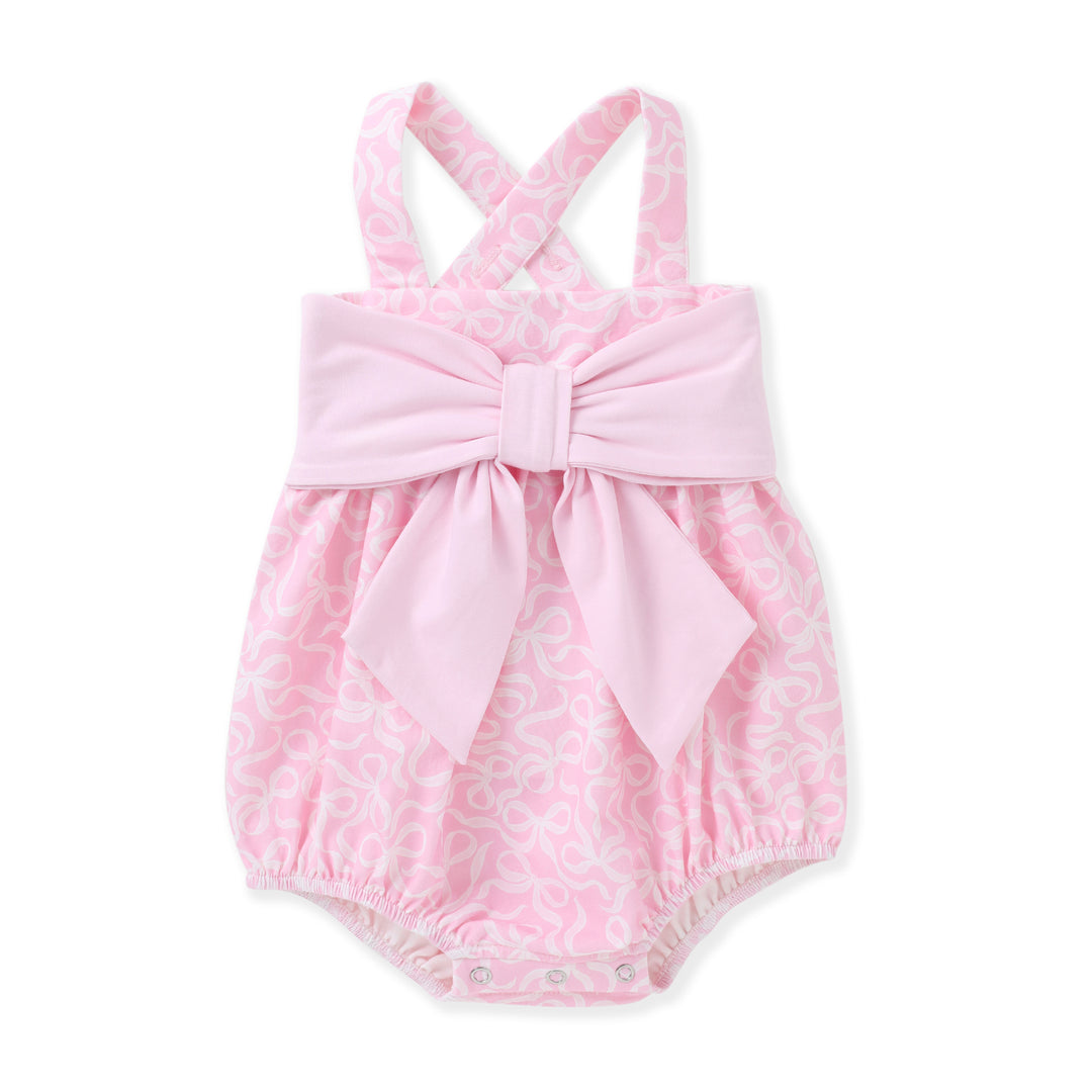 Pink baby romper with a bow on a white background