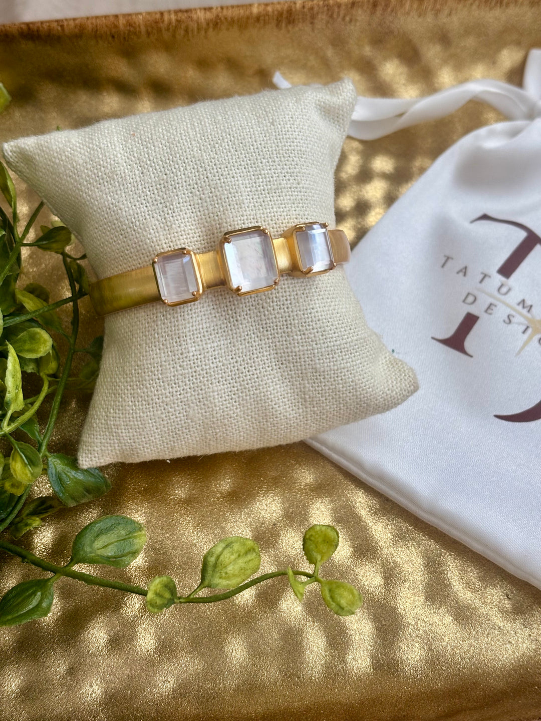 gold cuff on bracelet pillow with 3 mother of pearl stones