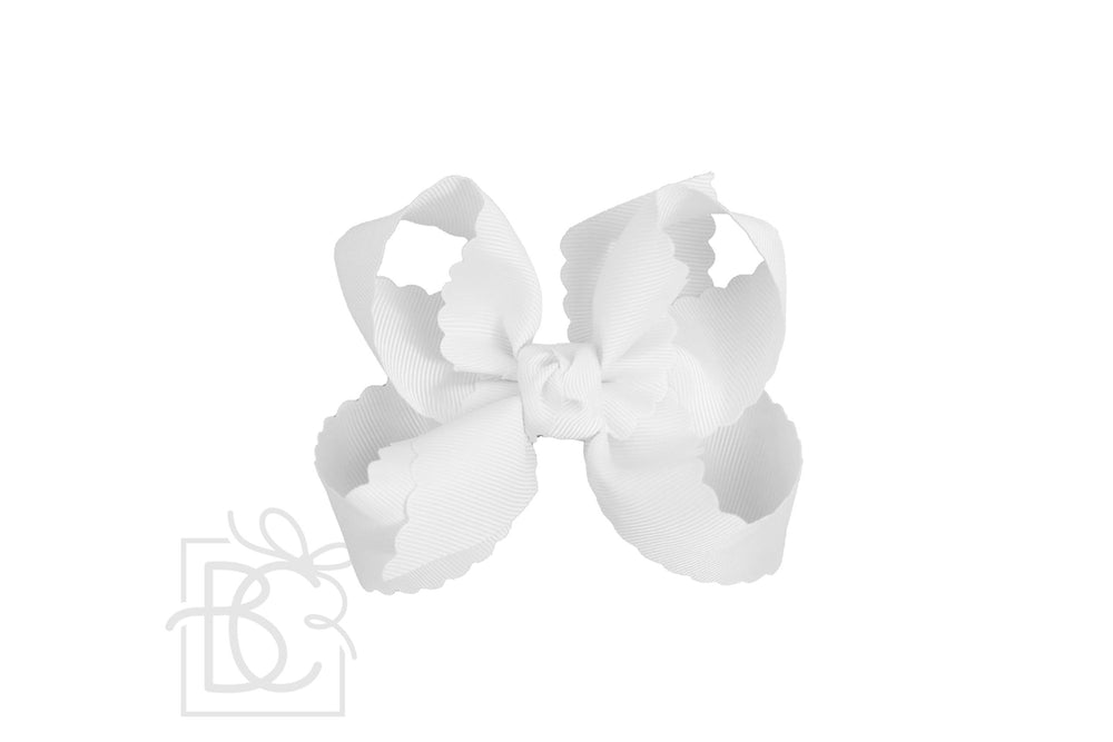 A white scalloped edge hair bow