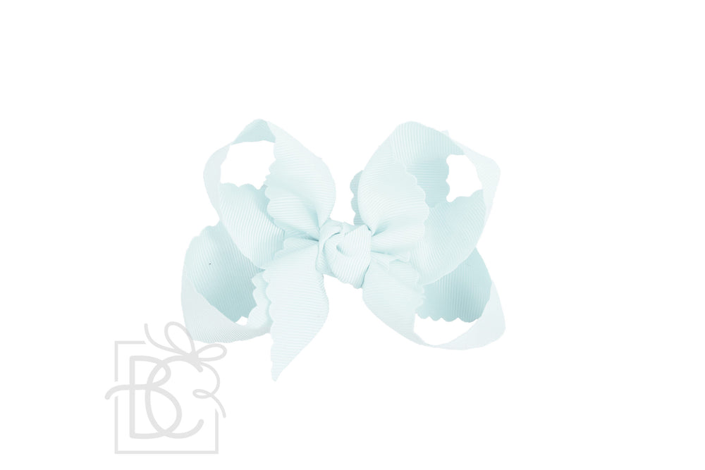 A powder blue scalloped edge hair bow.