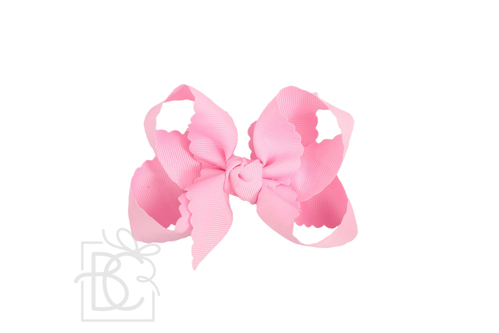 A pink scalloped edge bow