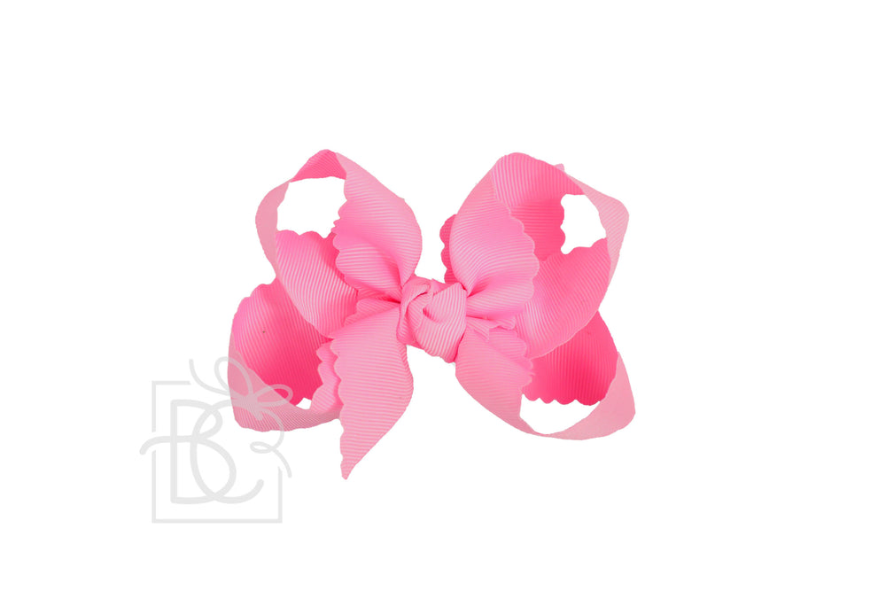A hot pink scalloped edge hair bow.