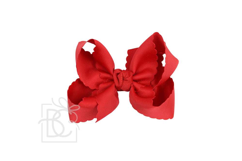 A red scalloped edge hair bow.