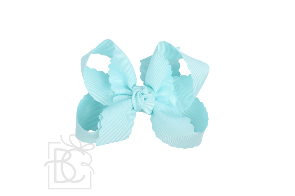 A light blue scalloped edge hair bow.
