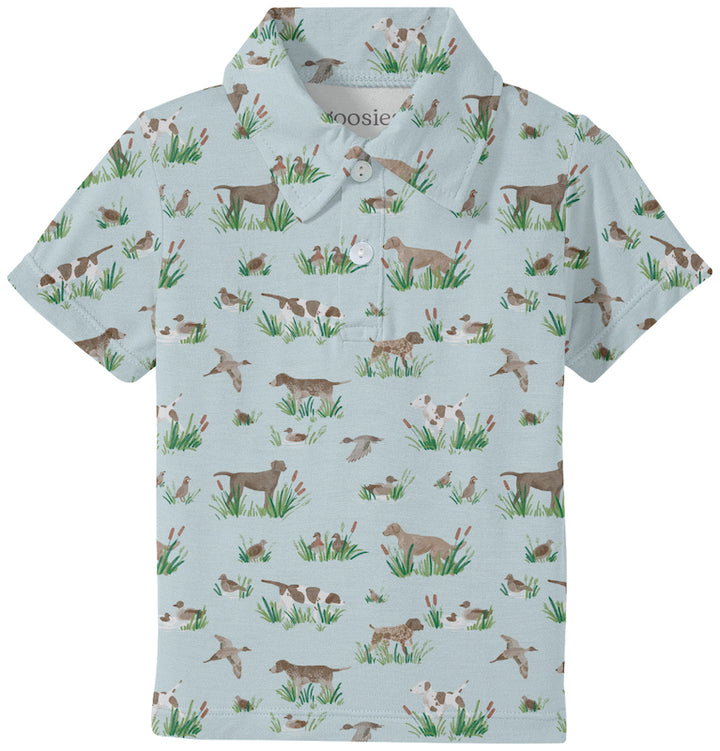Children's polo shirt with dog pattern on a light blue background