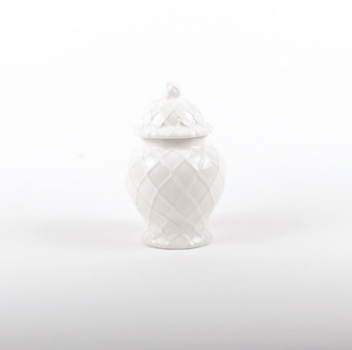 A small white textured ginger jar with lid on a white background.