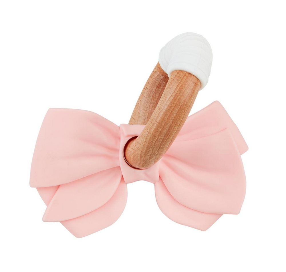 Two teething rings with a bow shape, one in pink and one in white, composed of natural beechwood and BPA free silicone.