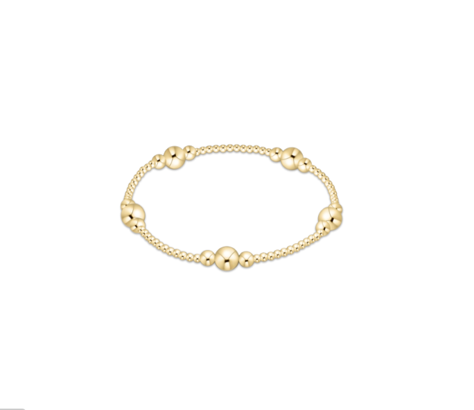 Gold bracelet with spherical beads on a white background