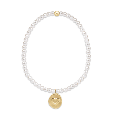 Pearl bracelet with a gold heart pendant on a white background