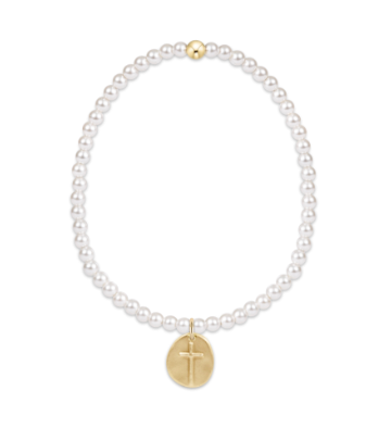 Pearl bracelet with a gold cross pendant on a white background