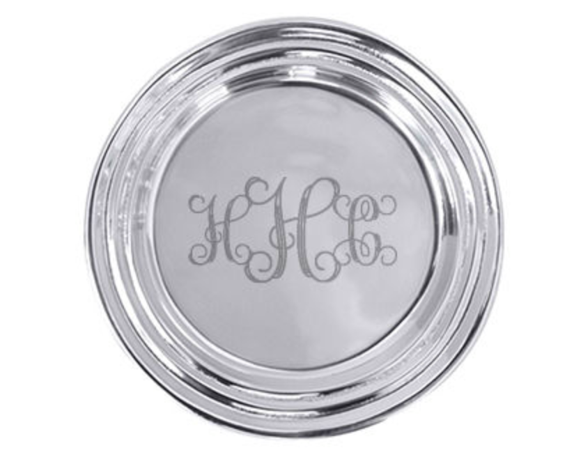 Round silver container with monogram on a white background