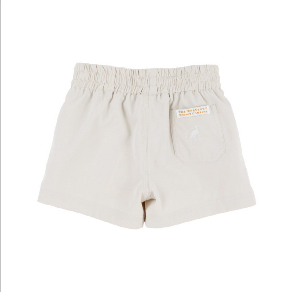 Beige shorts with a brand label on a white background