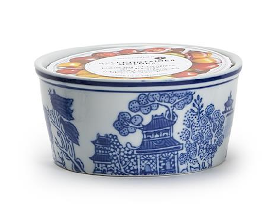 Decorative ceramic container with blue floral and pagoda design on a white background