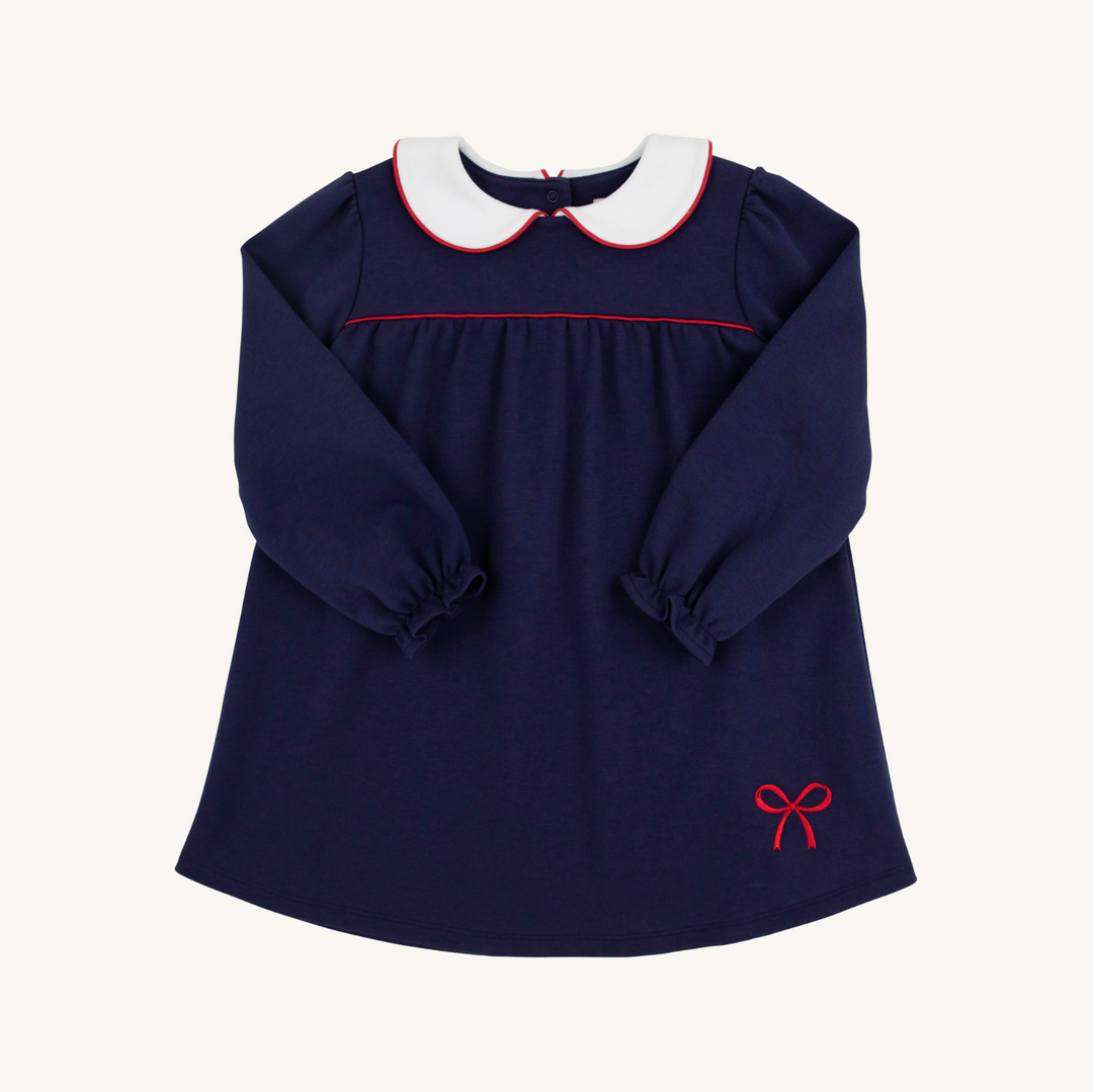 Navy blue dress with white collar and red trim on a white background