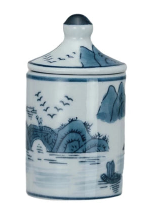Ceramic jar with blue and white landscape design on a white background