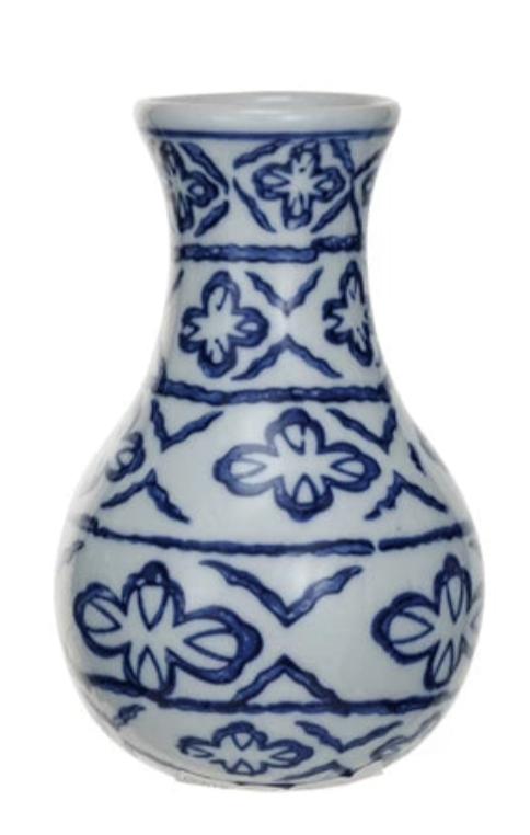 White vase with blue geometric pattern on a white background