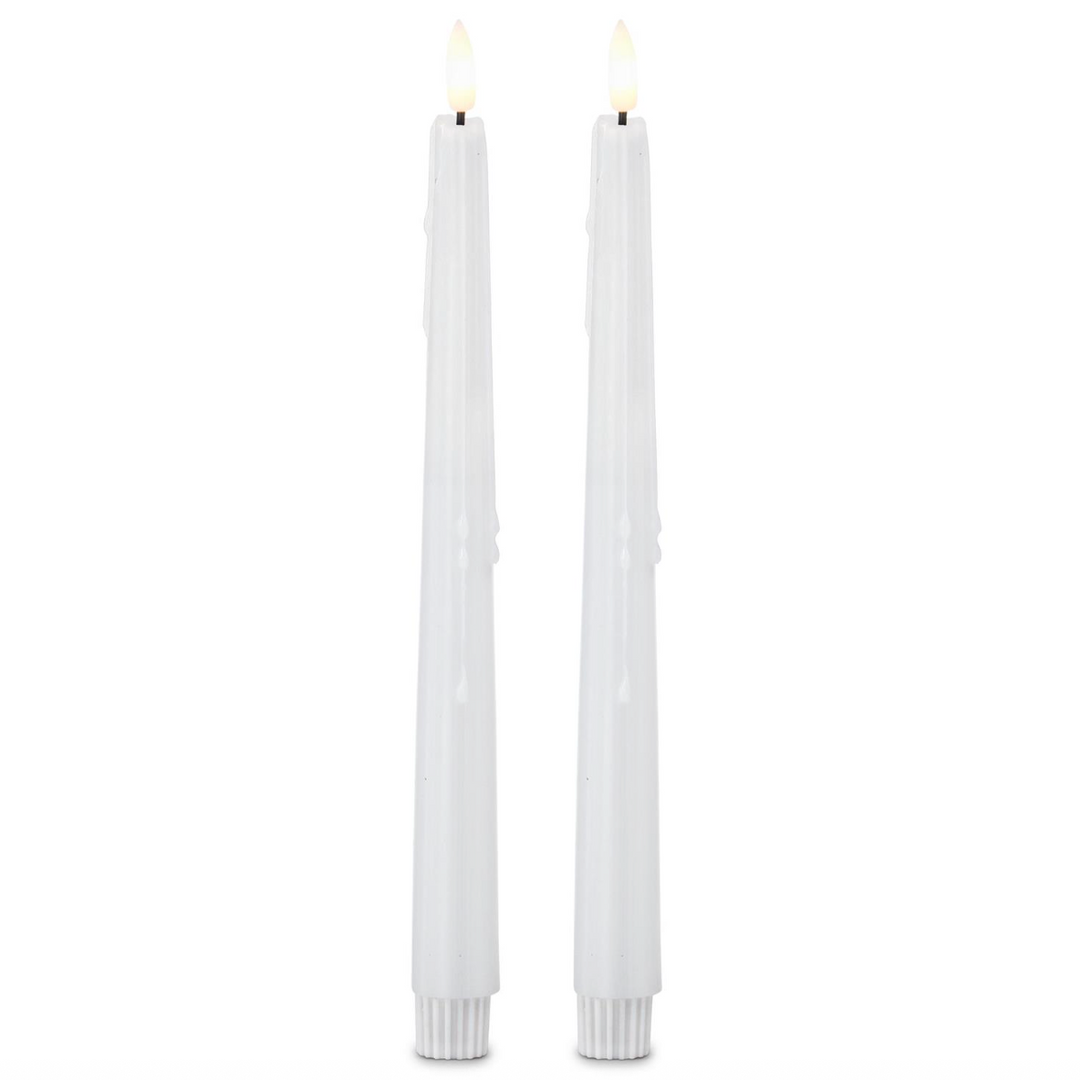 Two white candles on a white background