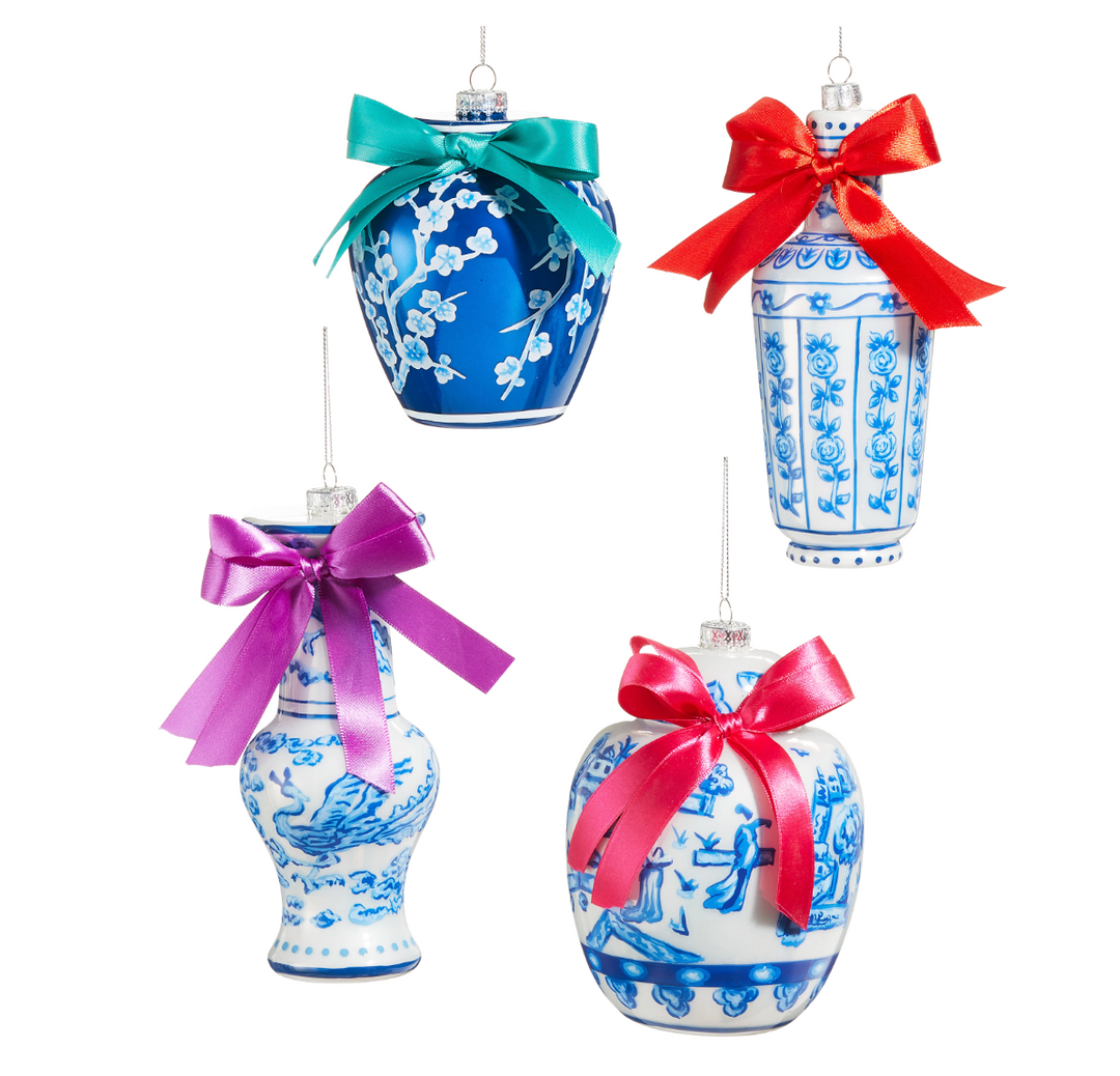 Four decorative vases with blue and white patterns and colorful bows on a white background