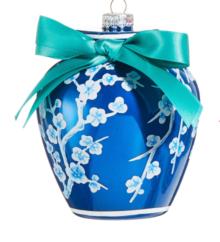 Blue ornament with white floral patterns and a turquoise ribbon on a white background