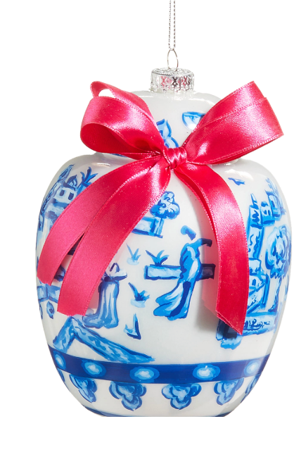 Decorative ceramic jar with blue patterns and a red ribbon on a white background