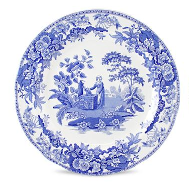 Decorative plate with blue floral and landscape design on a white background