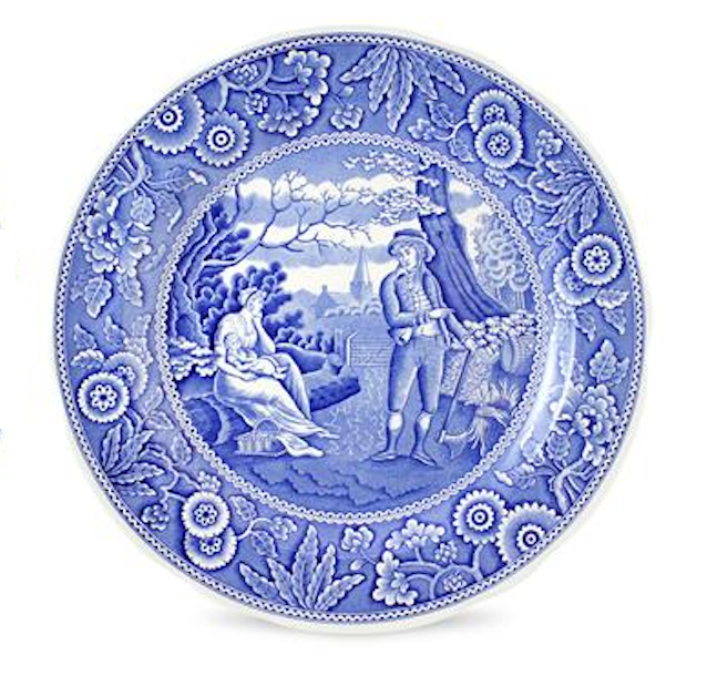 Decorative plate with blue and white design of a couple in a garden