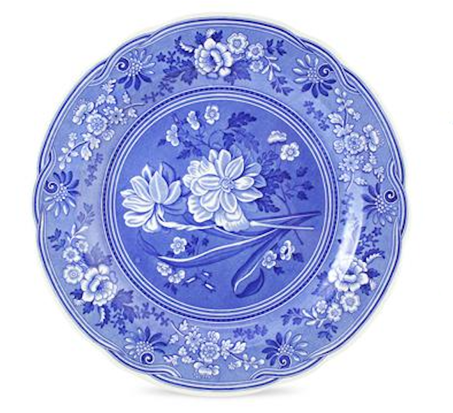 Blue ceramic plate with white floral patterns on a white background