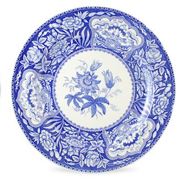 Blue and white decorative plate with floral patterns on a white background