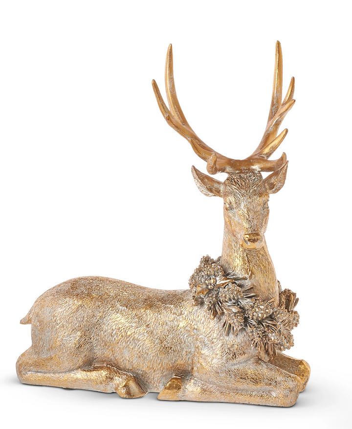Decorative gold deer figurine with antlers on a white background