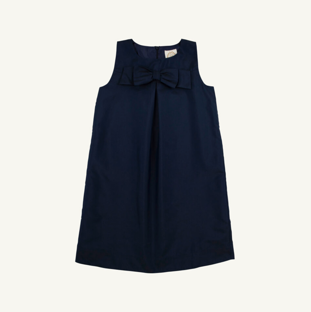 Navy blue dress with a bow detail on a white background