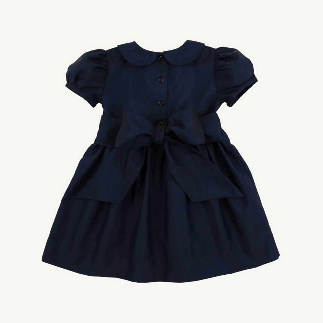 Navy blue dress with a bow on a white background