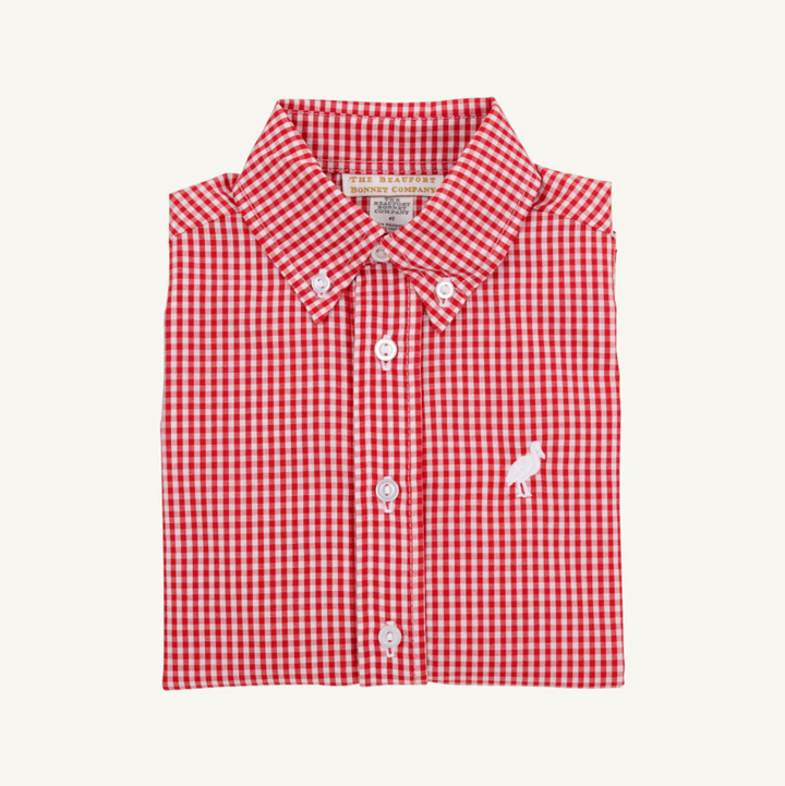 Folded red and white checkered shirt with a brand label on a white background