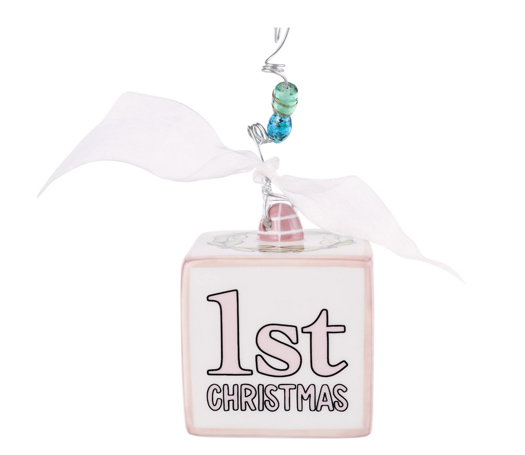 Decorative ornament with '1st Christmas' text on a white background