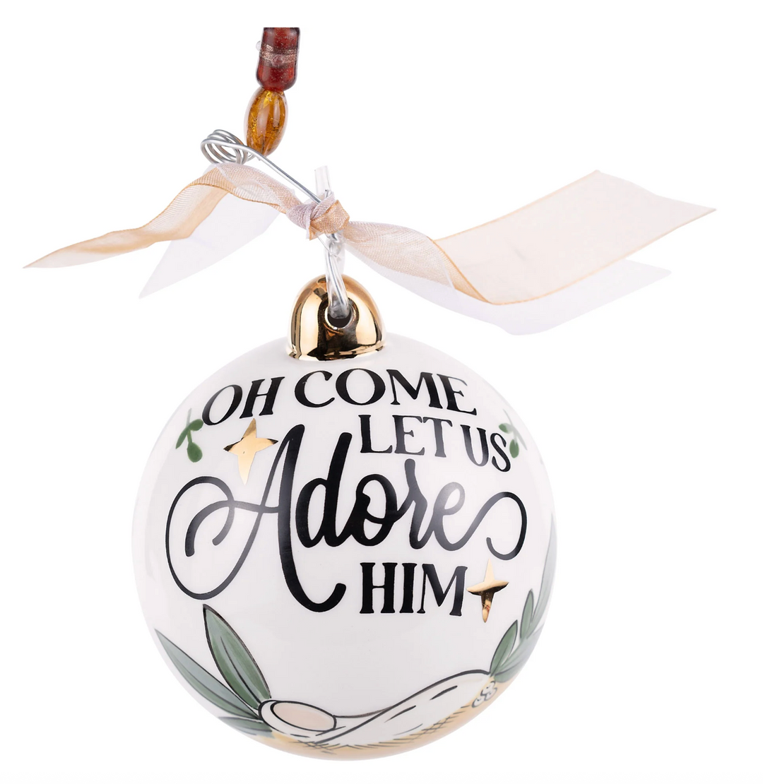 Decorative ornament with 'Oh Come Let Us Adore Him' text on a white background